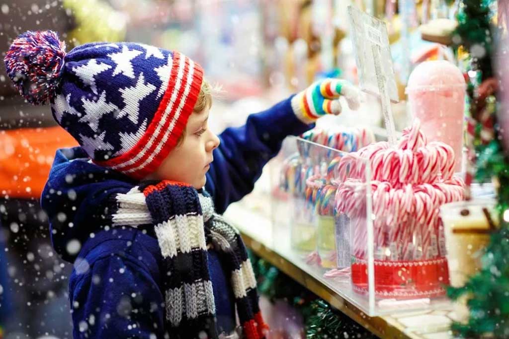 Little boy Christmas shopper choosing candy cane