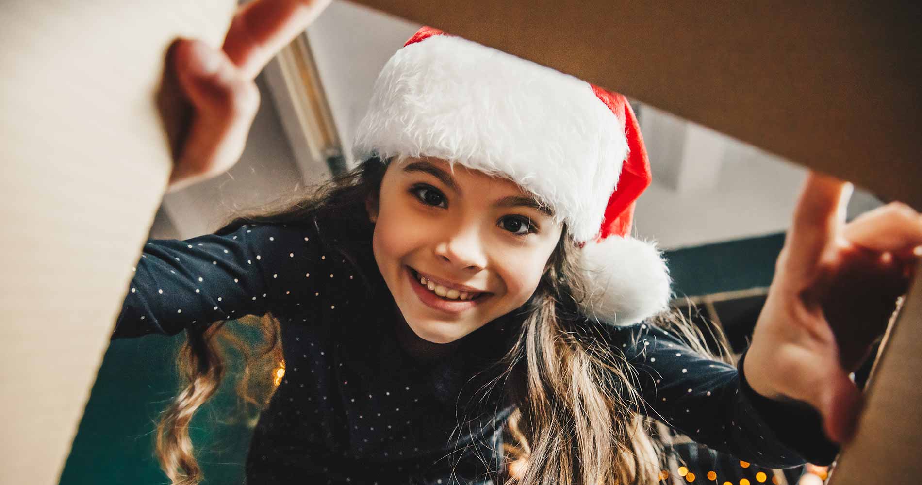 Young girl looking in Christmas box