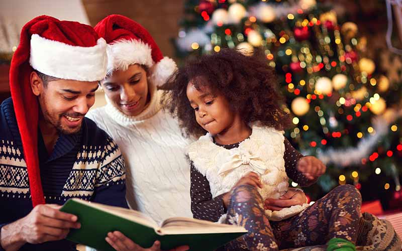 African American family reading Christmas stories