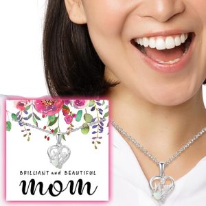Picture a joyful woman adorned with our elegant silver heart-shaped necklace, featuring the engraved word "Mom." Accompanying her radiant expression is a charming floral design and the heartfelt caption, "Brilliant and Beautiful Mom." This exquisite piece and many others are available in our exclusive holiday fundraising catalog, enabling schools and organizations to elevate their fundraising efforts through timeless gifts that celebrate loved ones. Unlock the potential of your holiday fundraiser by offering these treasured keepsakes to supporters eager to give something meaningful this season. Explore our catalog today!.