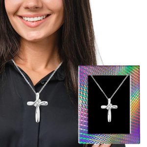 Capture the joy of giving and achieve your fundraising goals with our exclusive jewelry offers! Picture a woman beaming with happiness as she wears our exquisite silver cross necklace. The holographic frame beside her showcases the same stunning piece in all its glory, capturing the elegance and charm it brings. Offer this timeless treasure through your next holiday fundraiser catalog, inspiring generosity while supporting your cause. Elevate your fundraising efforts today—it’s more than just a necklace; it’s a symbol of success for your organization!.