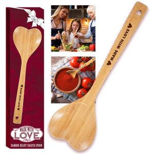 Introducing our charming Heart-Shaped Bamboo Spoon, beautifully engraved with the heartwarming message "Made with Love." Perfect for holiday fundraising, this delightful kitchen essential is paired alongside a festive red gift box and an inspiring photo of family togetherness in the kitchen—featuring a child, an adult, and an elderly loved one. Ideal for schools and organizations seeking to bring communities closer while raising essential funds this season. Let each spoon sold be a token of love shared and memories made!.